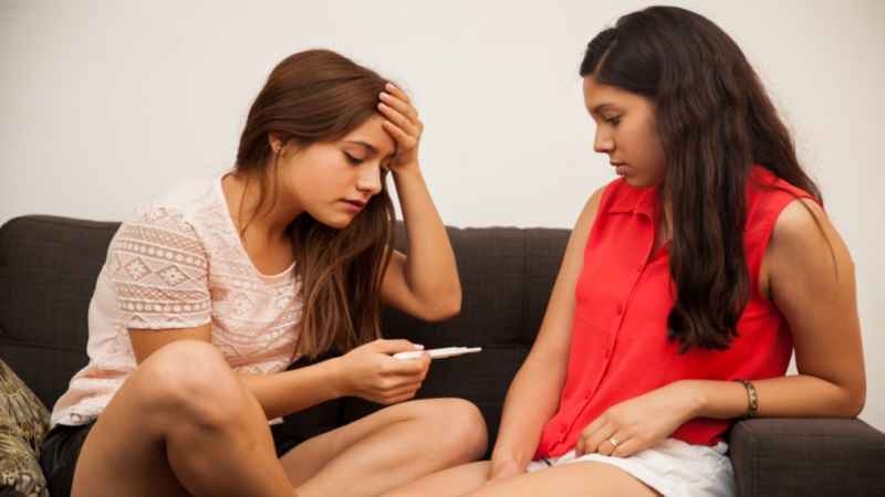 teen holding pregnancy test kit