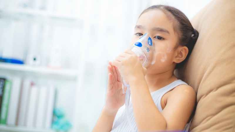 girl breathing with inhaler