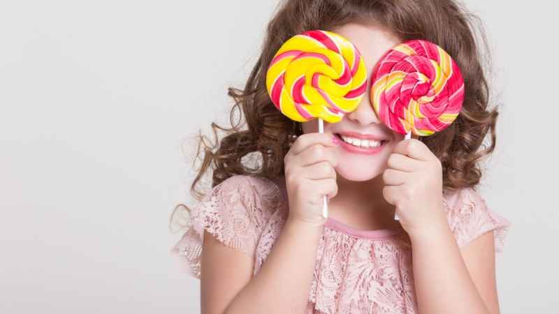 girl holding lollipop -Cut Down on Sugary Foods
