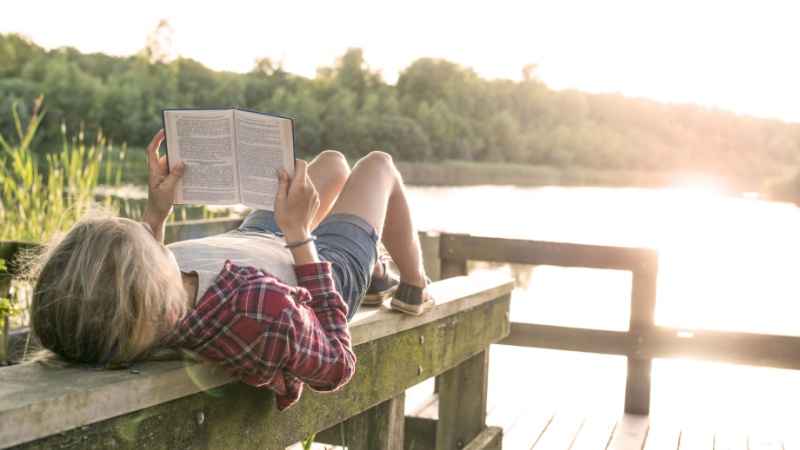 teen boy reading a good story book 