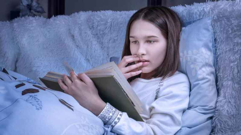 teen girl reading good book