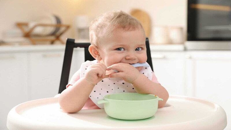 baby-with-bowl-and-spoon-in-chair