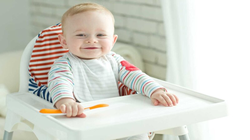 baby-with-spoon-on-high-chair