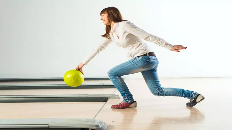 women-bent-down-while-bowling