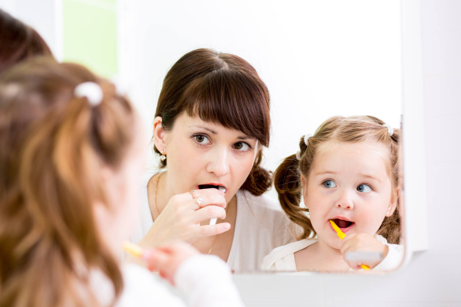 Demonstrate teeth brushing and rewarding