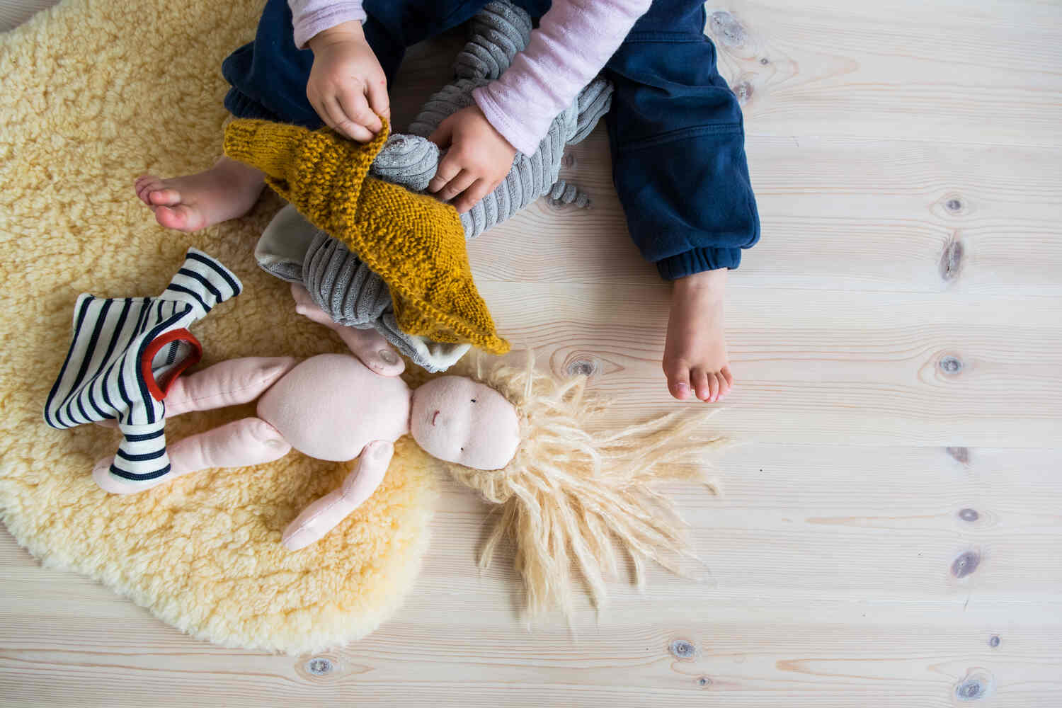 Let your toddler practice dressing and undressing on their toys