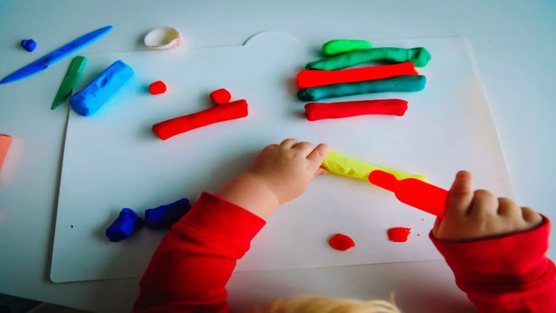 Toddler working with play dough