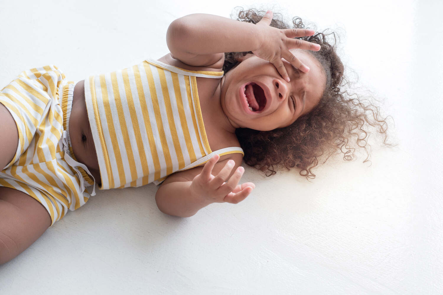 A toddler girl crying