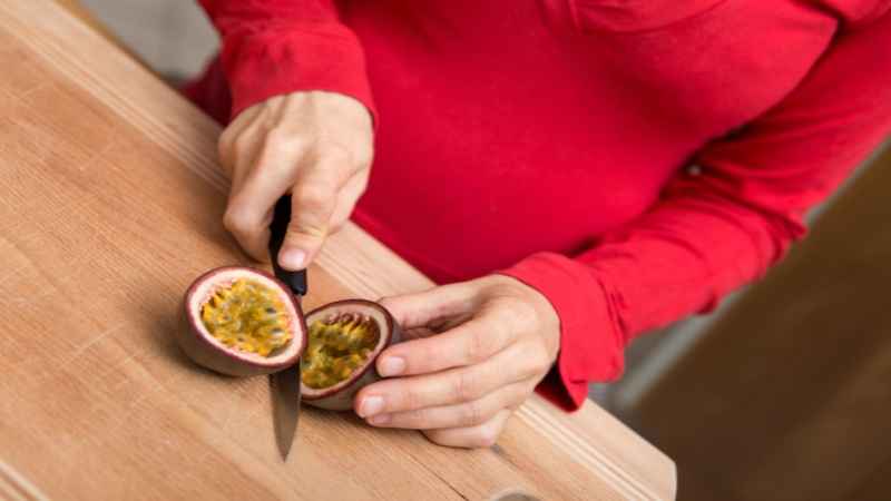 pregnant women cutting passion fruit