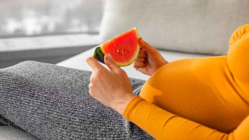 pregnant women holding water melon