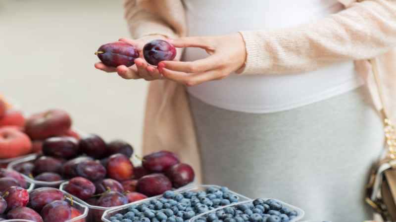 pregnant women with plums