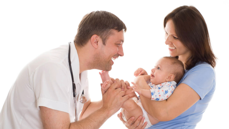 doctor checking infant