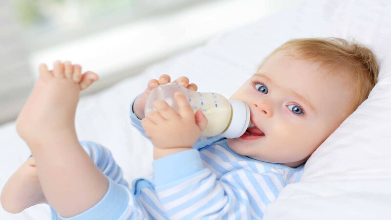 baby drinking powdered milk